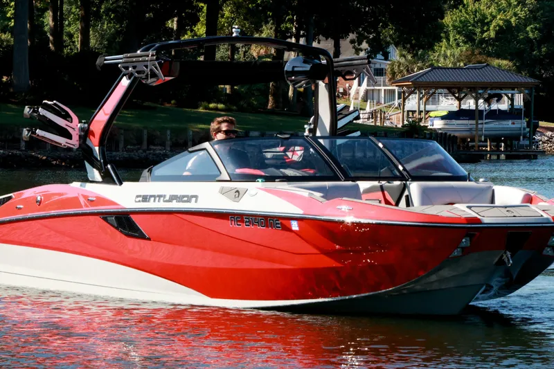Slide: The Image of 2024 Centurion Fi23 boat in vibrant red on a serene lake. - 3
