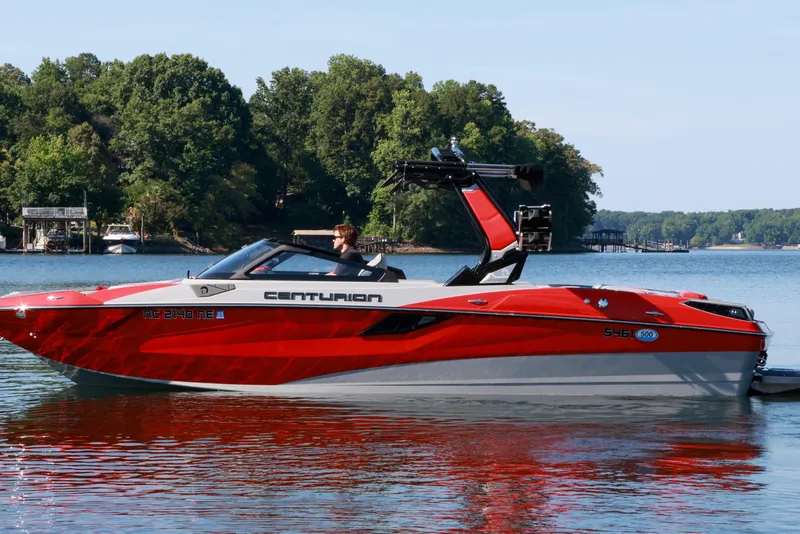 Slide: The Image of 2024 Centurion Fi23 boat in vibrant red on a serene lake. - 6