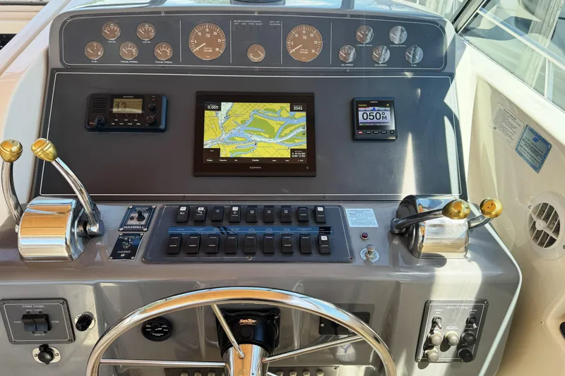 Slide: The Image of Control panel of a 1995 Tiara Yachts 4300 Open with navigation and throttle controls. - 13