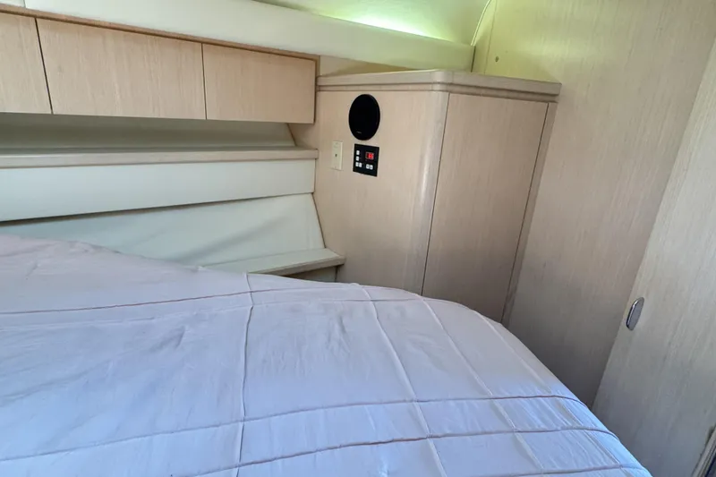 Slide: The Image of Cozy cabin interior of a 1995 Tiara Yachts 4300 Open, featuring light wood cabinetry. - 24
