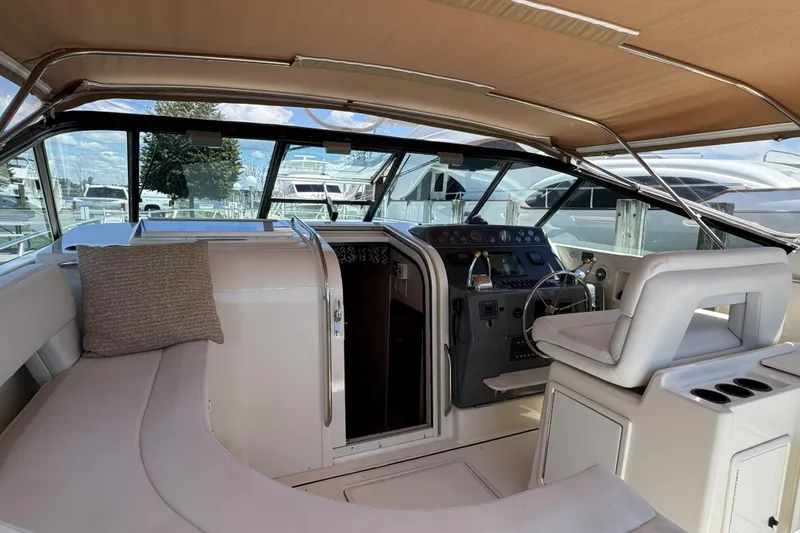Slide: The Image of Interior view of a 1995 Tiara Yachts 4300 Open, featuring helm and seating area. - 11
