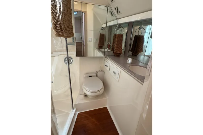 Slide: The Image of Bathroom interior of 1995 Tiara Yachts 4300 Open, featuring toilet, sink, and mirror. - 27