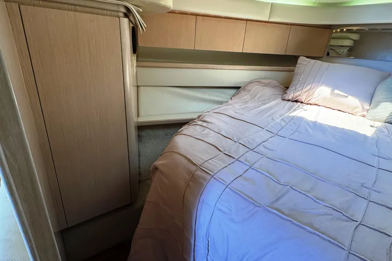 Slide: The Image of 1995 Tiara Yachts 4300 Open cabin interior with bed and wooden cabinetry. - 25