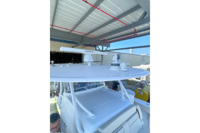Slide: The Image of 2025 Jupiter 43 boat with Garmin radar and FLIR camera under a metal roof. - 9