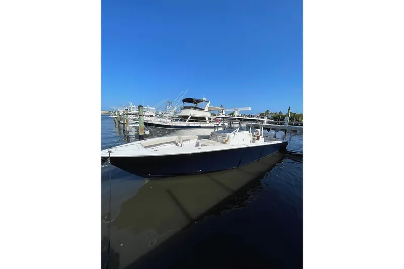 Slide: The Image of 2025 Jupiter 43 boat docked at marina under clear blue sky. - 24