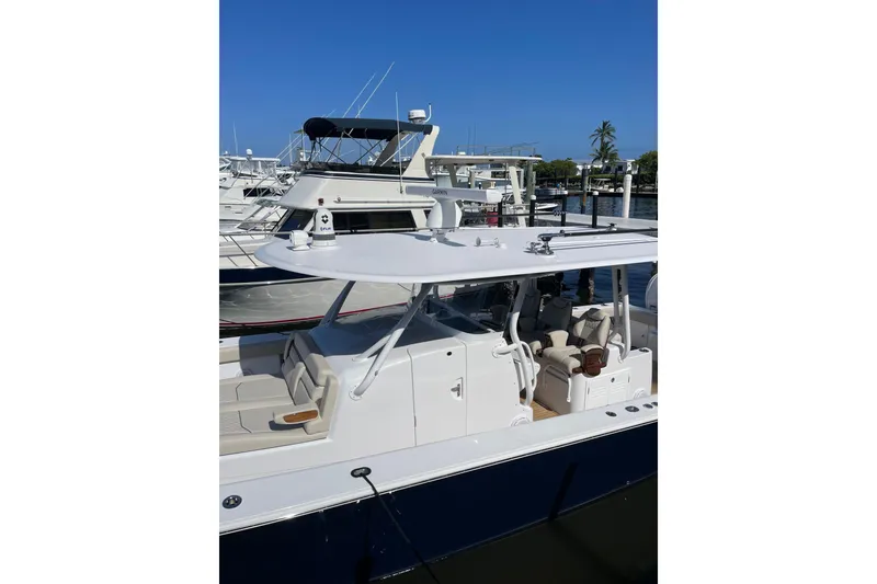Slide: The Image of 2025 Jupiter 43 boat docked at marina under clear blue sky. - 25