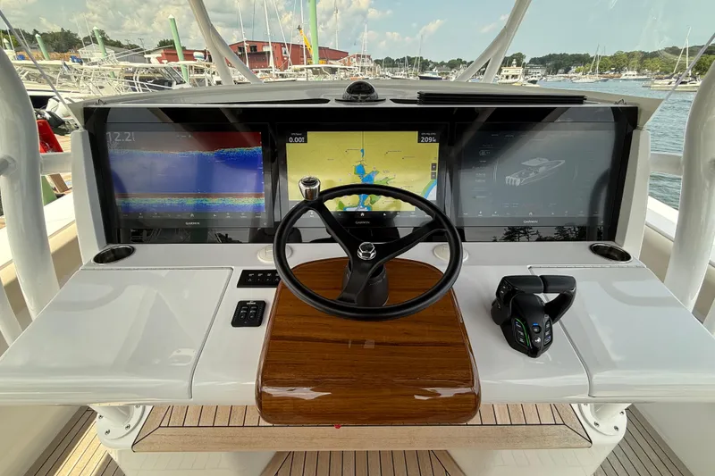 Slide: The Image of Helm of 2025 Jupiter 43 boat with advanced navigation displays and controls. - 7