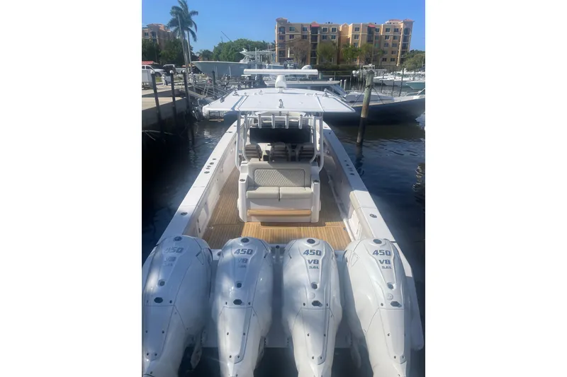Slide: The Image of 2025 Jupiter 43 boat with four powerful 450 V8 engines docked at marina. - 7