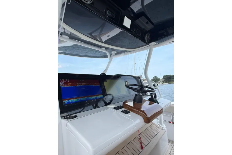 Slide: The Image of Helm of 2025 Jupiter 43 boat with advanced navigation displays and steering wheel. - 40