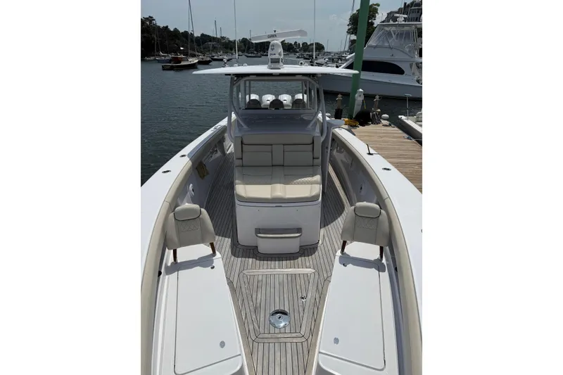 Slide: The Image of 2025 Jupiter 43 boat docked, featuring spacious seating and sleek design. - 43