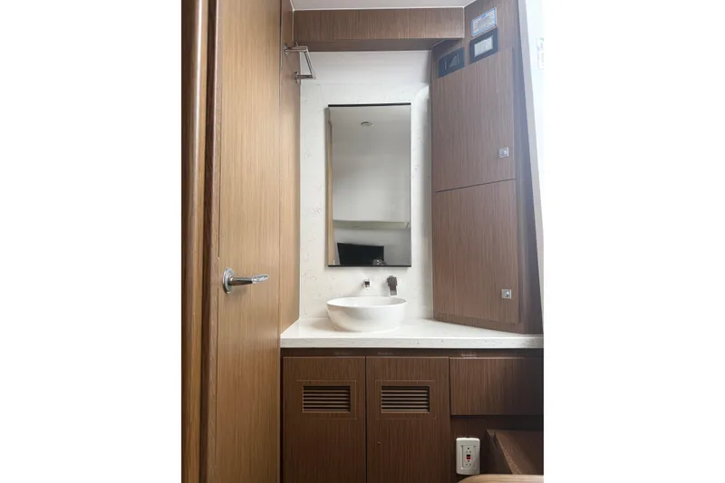 Slide: The Image of Modern bathroom interior on Jupiter 43 yacht, featuring wooden cabinetry and sleek fixtures, 2025 model. - 34