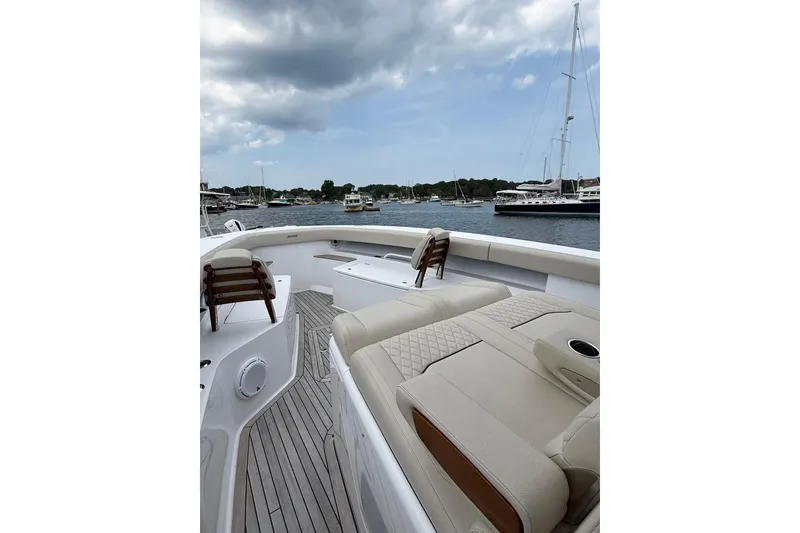 Slide: The Image of Luxurious 2025 Jupiter 43 yacht deck with seating, overlooking marina and sailboats. - 30