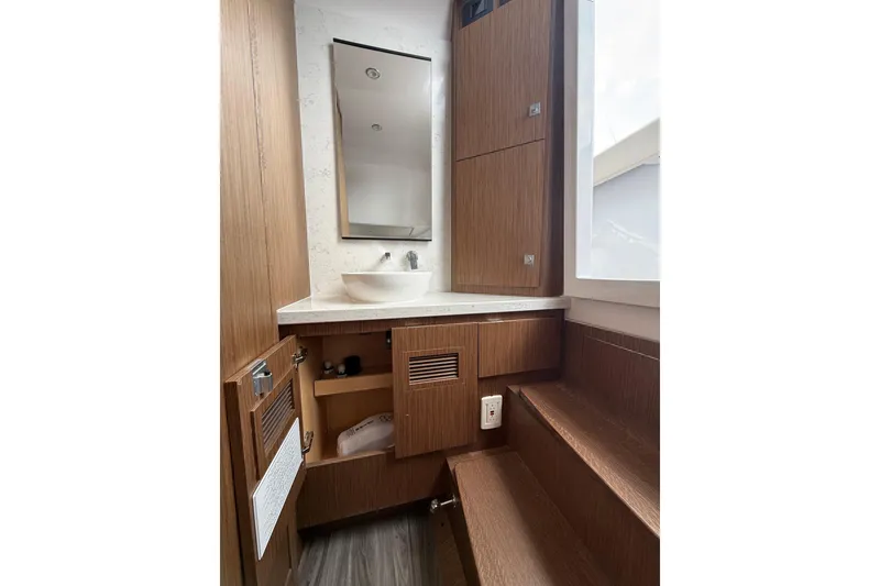 Slide: The Image of Modern bathroom interior in Jupiter 43, 2025 model, featuring wood cabinetry and sleek fixtures. - 32