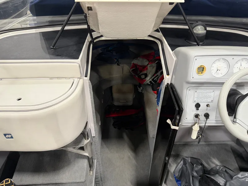 Slide: The Image of Interior view of a 1992 Four Winns 225 Sundowner with gray carpet and dashboard. - 13