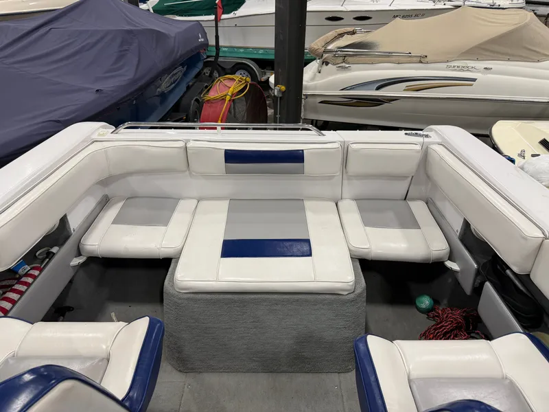 Slide: The Image of Interior of a 1992 Four Winns 225 Sundowner with white and blue seating. - 9