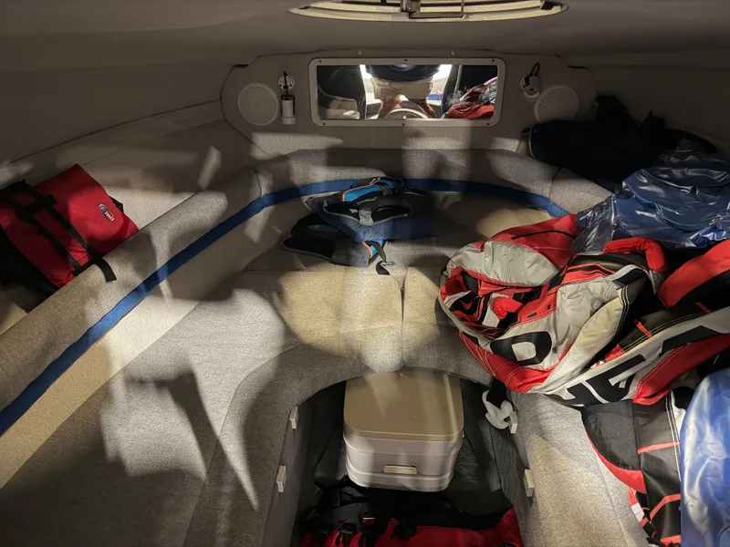 Slide: The Image of Interior of a 1992 Four Winns 225 Sundowner with seating and storage space. - 15