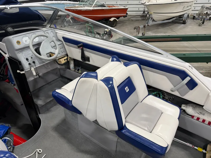 Slide: The Image of Interior view of a 1992 Four Winns 225 Sundowner with blue and white seating. - 12