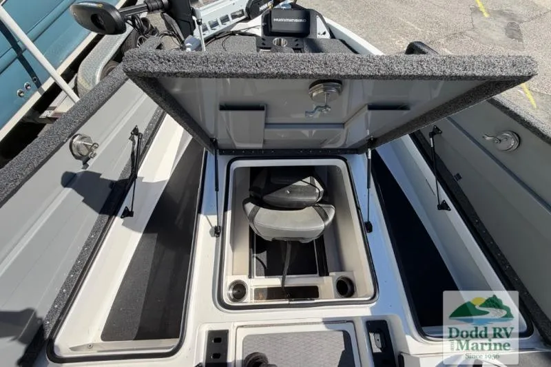 Slide: The Image of 2021 Caymas CX 18 SS boat storage compartment open, showcasing interior seating and equipment. - 15