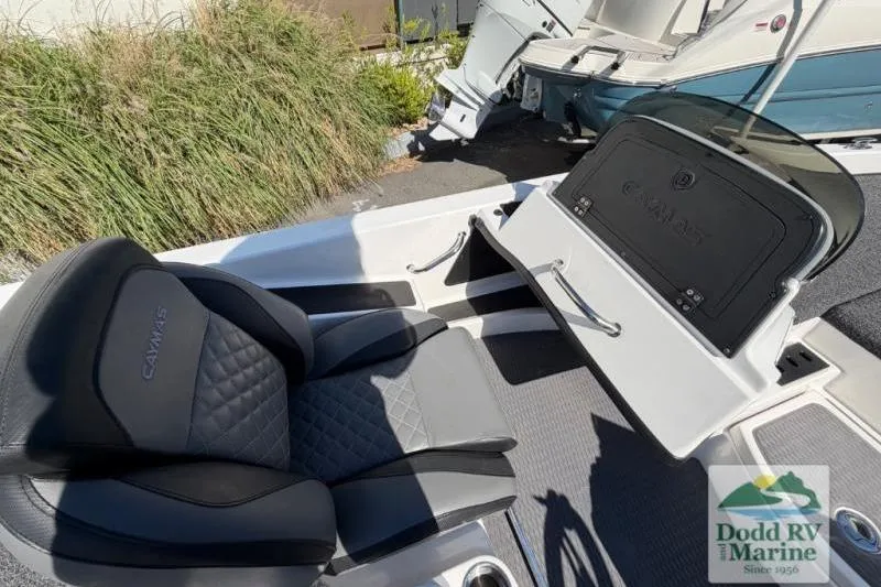 Slide: The Image of 2021 Caymas CX 18 SS boat interior with cushioned seating and storage compartment. - 13