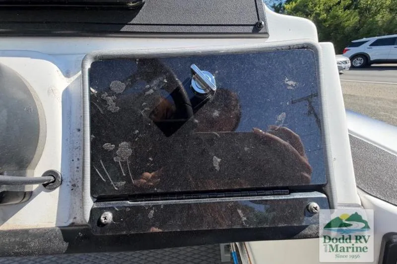 Slide: The Image of 2021 Caymas CX 18 SS dashboard with reflective surface and Dodd RV Marine logo. - 10