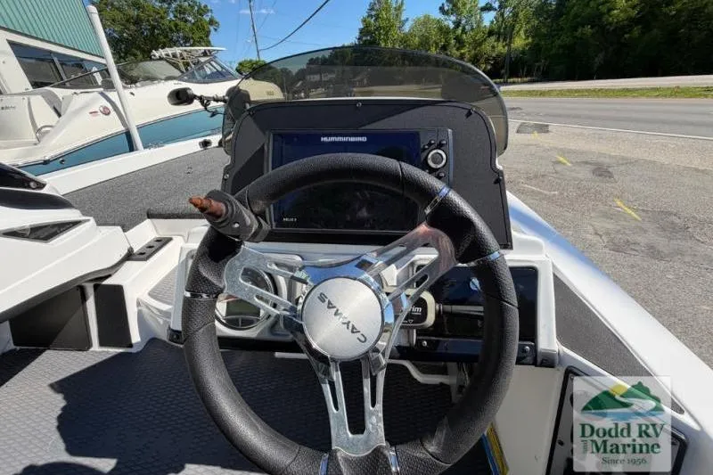 Slide: The Image of 2021 Caymas CX 18 SS boat dashboard with steering wheel and navigation display. - 8