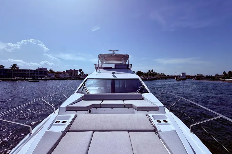 Slide: The Image of Azimut Fly 60 yacht cruising on a sunny day, showcasing luxurious deck seating. - 59