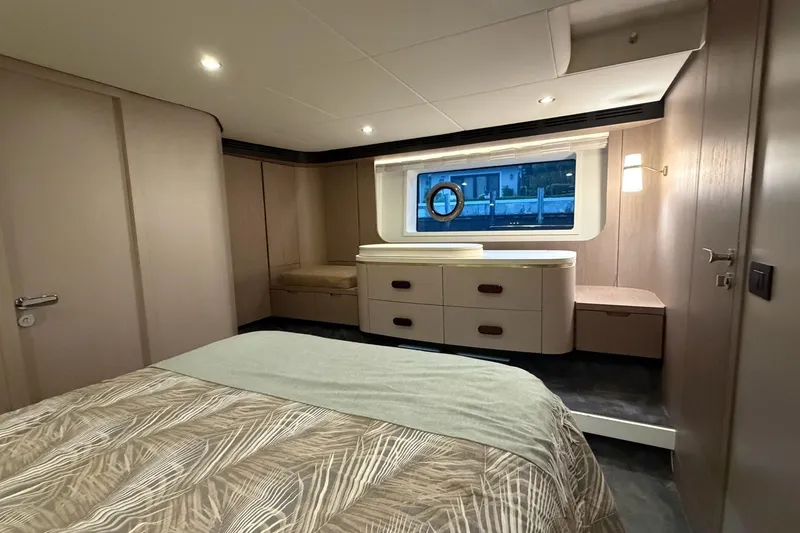 Slide: The Image of Luxurious bedroom interior of 2021 Azimut Fly 60 yacht with modern furnishings and window view. - 42