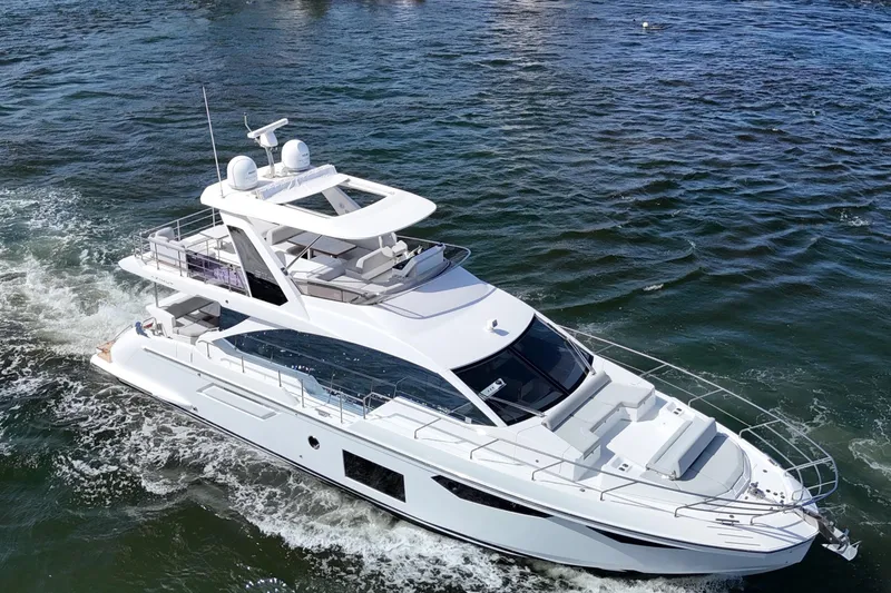 Slide: The Image of Luxury 2021 Azimut Fly 60 yacht cruising on open water. - 5