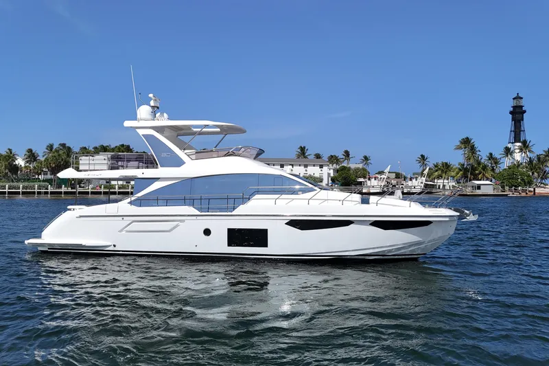 Slide: The Image of 2021 Azimut Fly 60 yacht cruising on a sunny day near a lighthouse. - 3