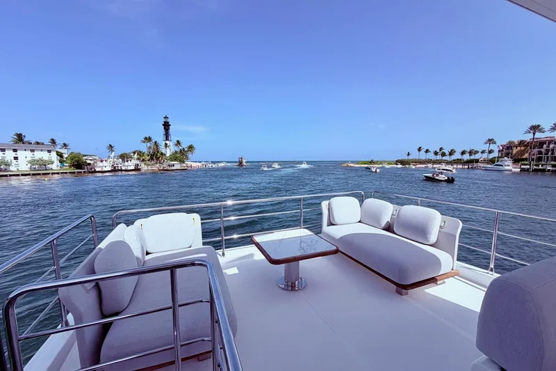 Slide: The Image of Luxurious 2021 Azimut Fly 60 yacht deck with ocean view and lighthouse in background. - 38
