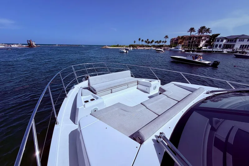 Slide: The Image of Luxurious 2021 Azimut Fly 60 yacht with spacious deck, cruising in scenic coastal waters. - 60