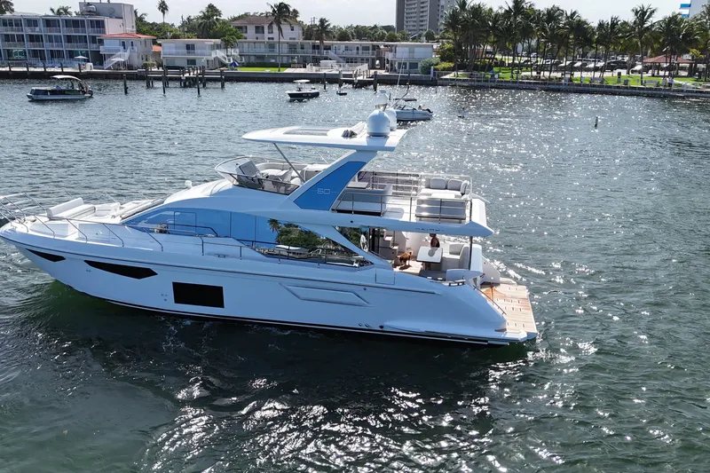Slide: The Image of 2021 Azimut Fly 60 yacht cruising on a sunny waterfront. - 6