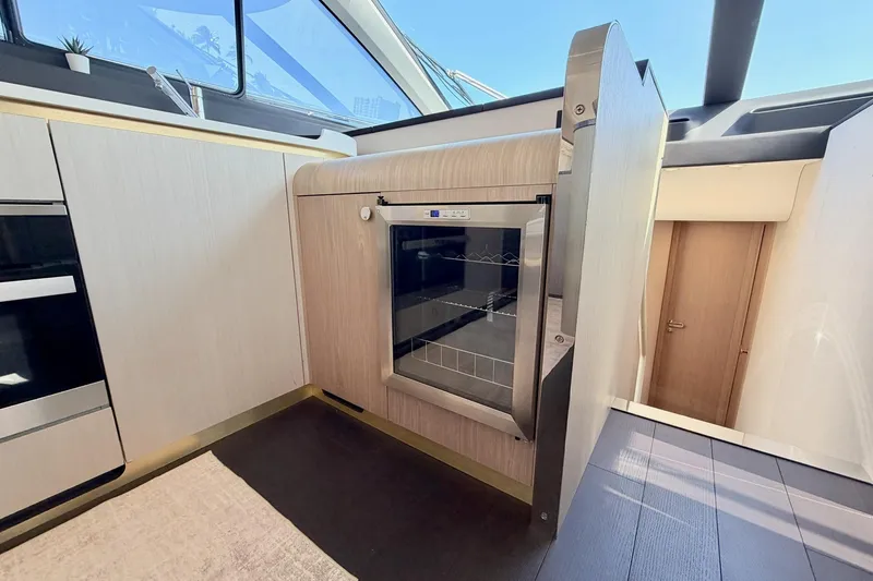 Slide: The Image of Modern kitchen interior on 2021 Azimut Fly 60 yacht, featuring sleek cabinetry and appliances. - 27