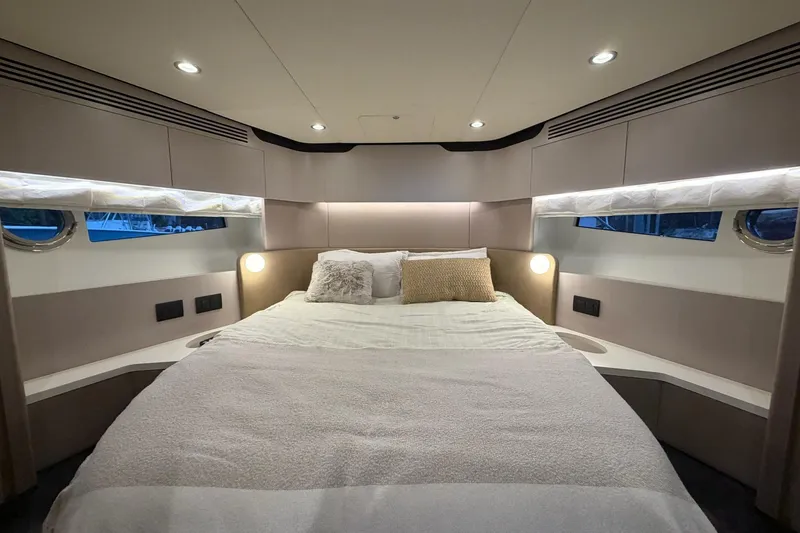 Slide: The Image of Luxurious bedroom interior of 2021 Azimut Fly 60 yacht with modern lighting and cozy bedding. - 48