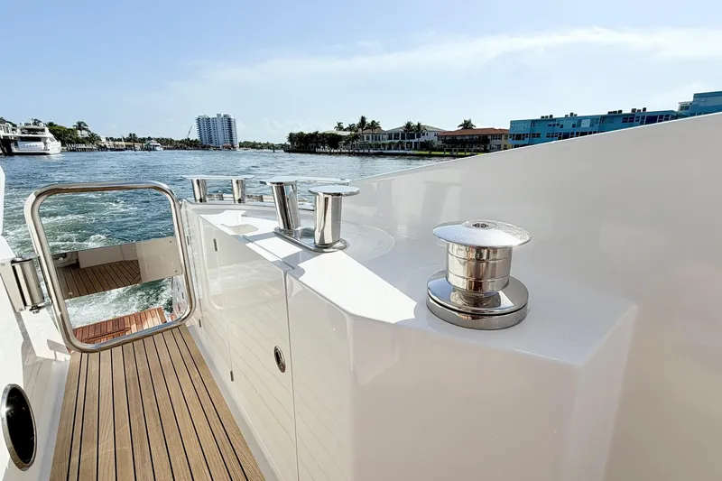 Slide: The Image of Azimut Fly 60 yacht deck, 2021 model, cruising on a sunny day near waterfront buildings. - 64
