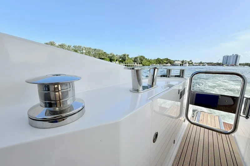 Slide: The Image of 2021 Azimut Fly 60 yacht deck with chrome fittings and scenic waterfront view. - 65