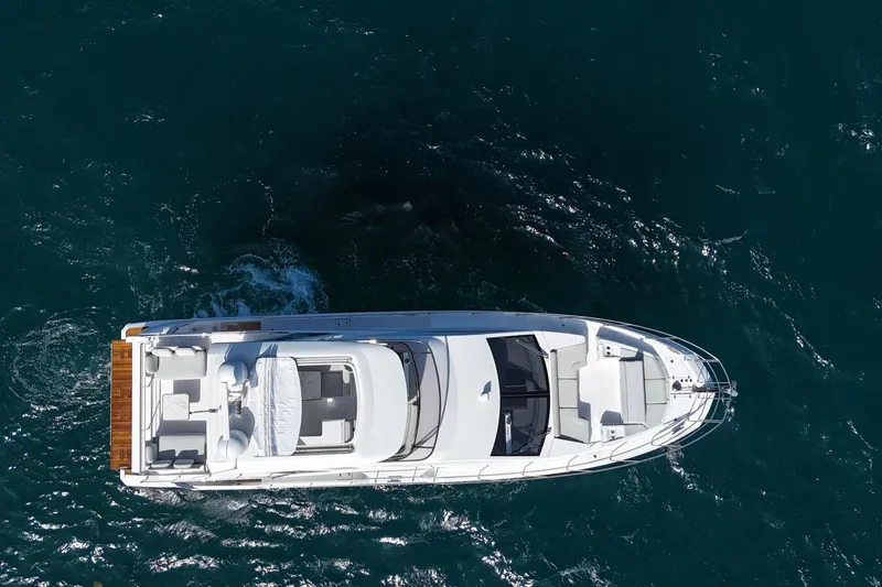 Slide: The Image of Aerial view of 2021 Azimut Fly 60 yacht cruising on open water. - 57