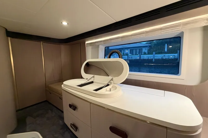 Slide: The Image of Luxurious interior of 2021 Azimut Fly 60 yacht with elegant cabinetry and large window view. - 44