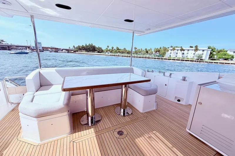 Slide: The Image of Luxurious 2021 Azimut Fly 60 yacht deck with elegant seating and scenic waterfront view. - 13