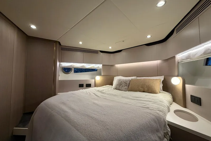 Slide: The Image of Luxurious bedroom interior of 2021 Azimut Fly 60 yacht with modern lighting and cozy bedding. - 47
