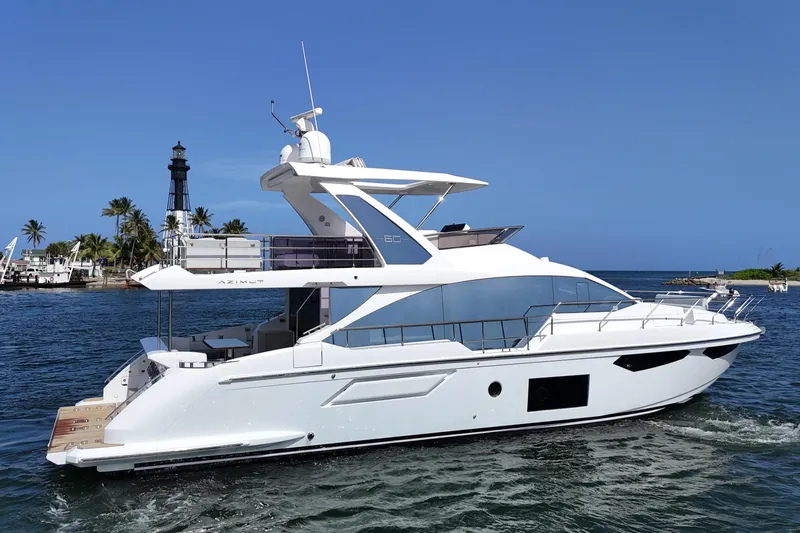Slide: The Image of Azimut Fly 60 yacht cruising near a lighthouse, 2021 model, in a tropical setting. - 4