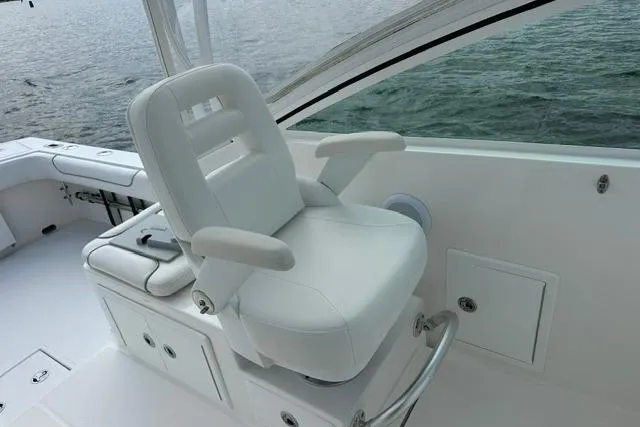 Slide: The Image of Captain's chair on 2019 Albemarle 25 Express boat, overlooking water. - 16