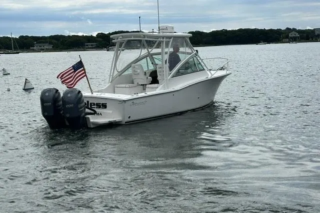 Slide: The Image of 2019 Albemarle 25 Express boat with dual engines on a calm lake. - 8