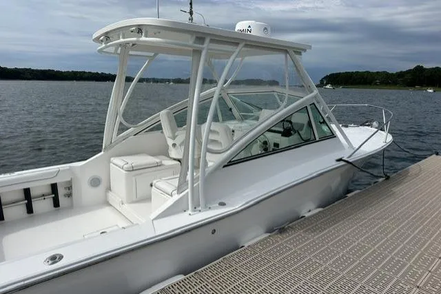 Slide: The Image of 2019 Albemarle 25 Express boat docked by a serene lake under cloudy skies. - 28