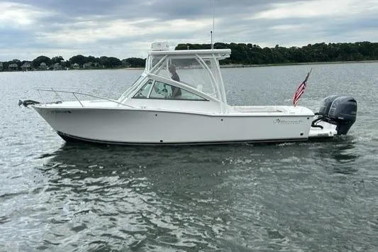 Slide: The Image of 2019 Albemarle 25 Express boat cruising on calm waters with American flag. - 12