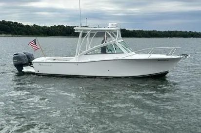 Slide: The Image of 2019 Albemarle 25 Express boat on water with American flag, overcast sky. - 3