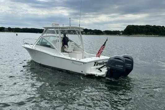 Slide: The Image of 2019 Albemarle 25 Express boat with dual engines on a calm waterway. - 9