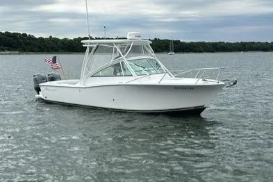 Slide: The Image of 2019 Albemarle 25 Express boat on calm water with American flag. - 2
