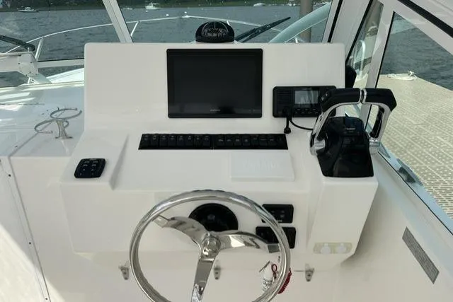 Slide: The Image of Helm of 2019 Albemarle 25 Express boat with steering wheel and navigation controls. - 13