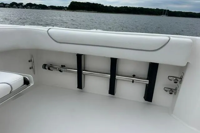 Slide: The Image of 2019 Albemarle 25 Express boat interior with rod holders, white seating, and scenic water view. - 23